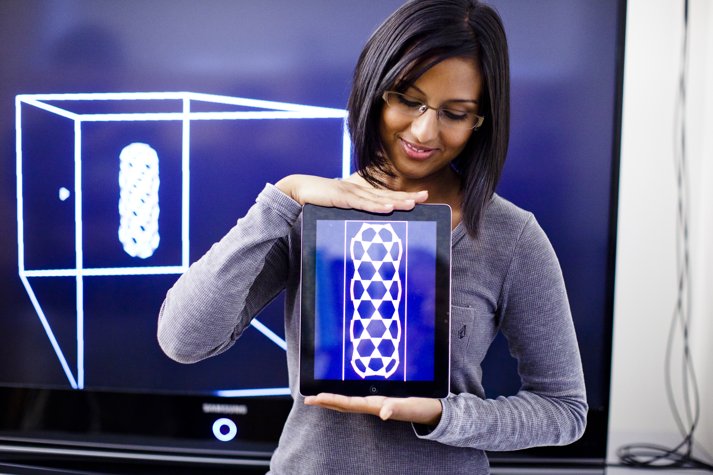 Student holding an ipad.