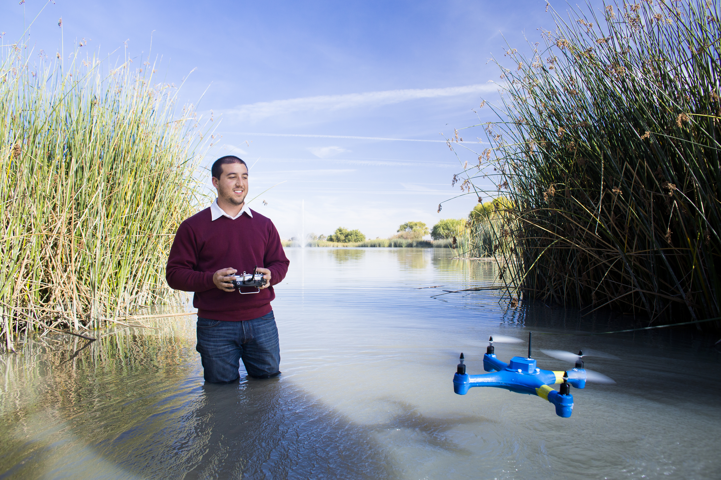 Person in water with drone flying.