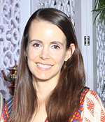 female with brown hair and orange and beige shirt