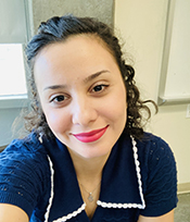 graduate student with brown hair and a blue shirt