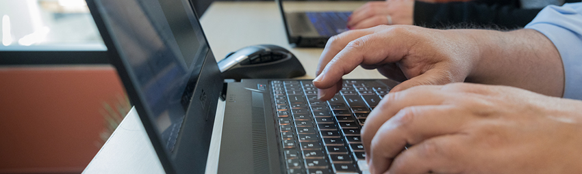 Two people using laptops.