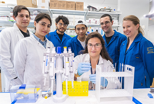 Group of students and faculty in a lab.