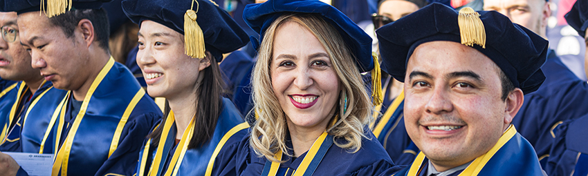 Group of graduates at spring commencement ceremony.