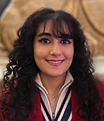 grad student with brown hair and red blazer 