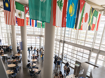 International flags hanging from the ceiling in the Kolligian Library Lantern.
