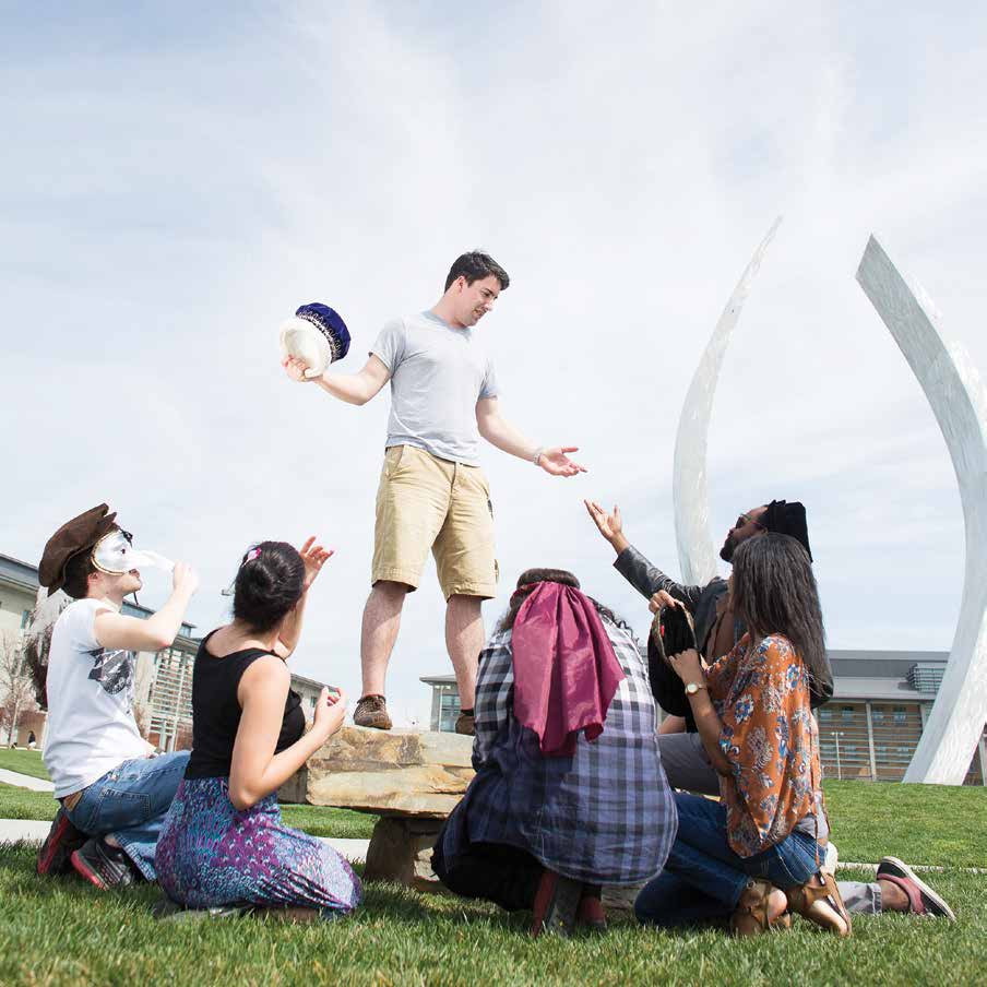 Students dressed up on the lawn in the quad near Beginnings Sculpture