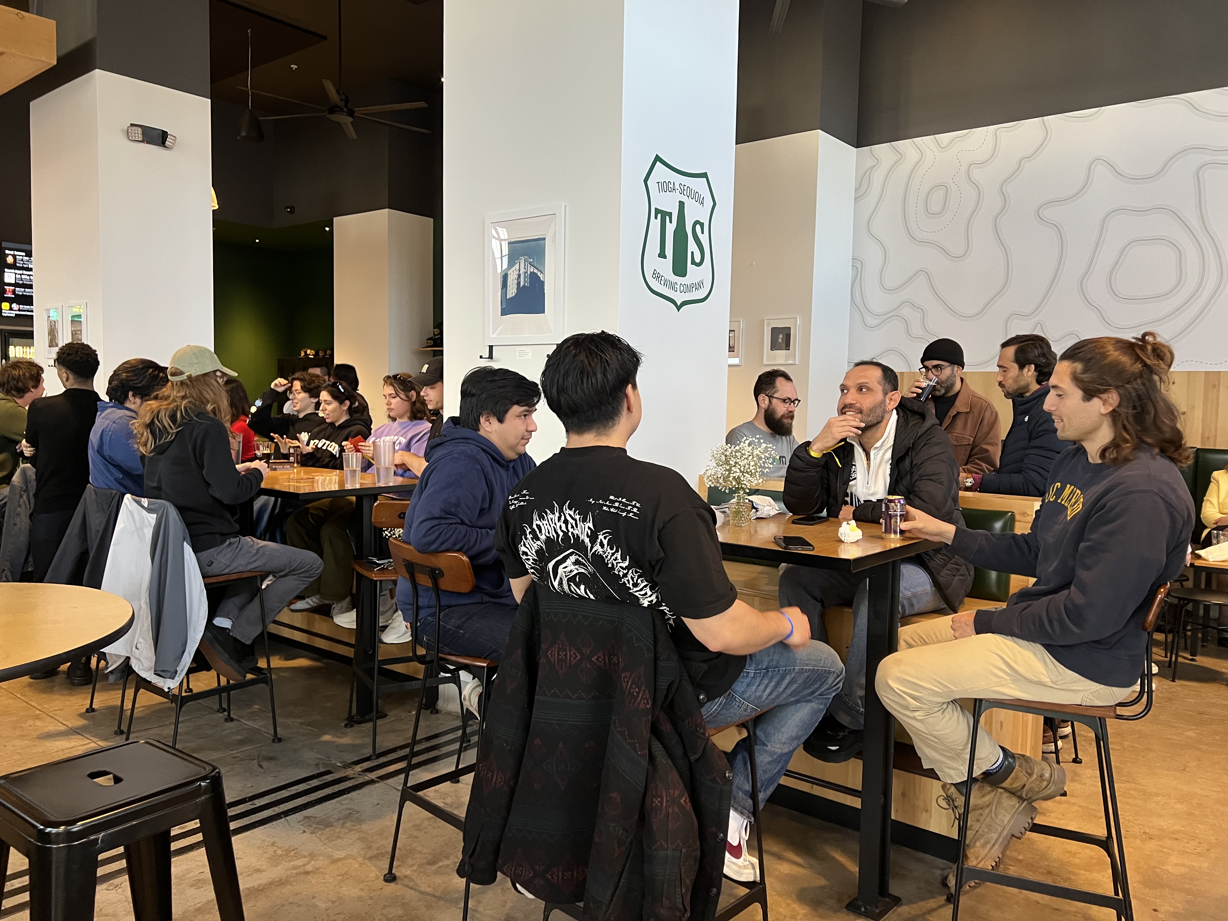 Group of uc merced grad student sitting at event in downtown merced.