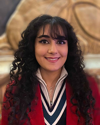 grad student with brown hair and red blazer 