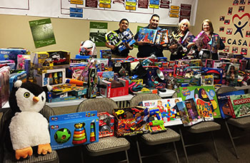 CASA representatives receive gifts donated by UC Merced campus members for children of Merced County. 