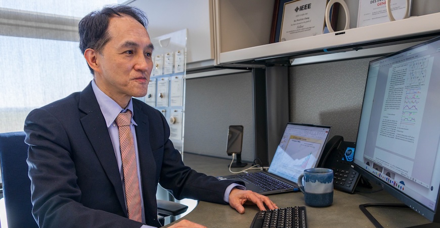 Photo depicts electrical engineering Professor Eric Cheng at his desk at UC Merced.