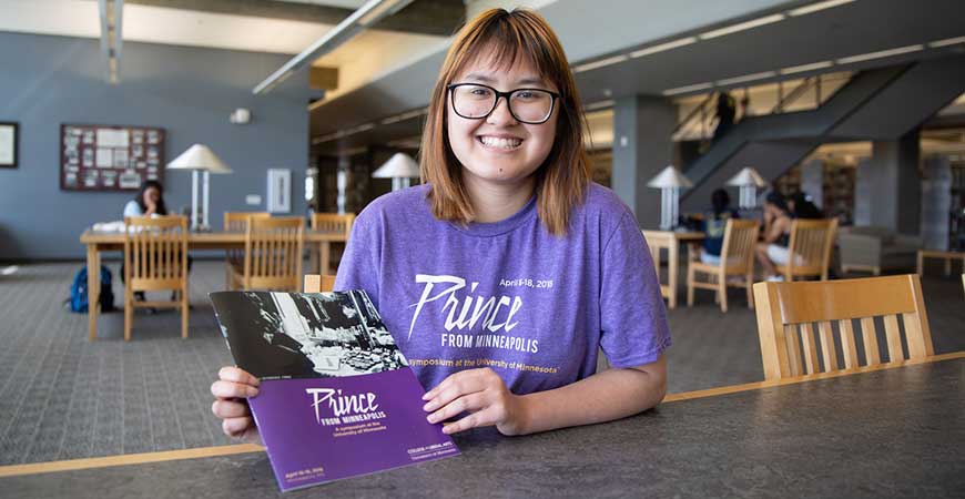 Graduate student Dalena Ngo poses seated at table.