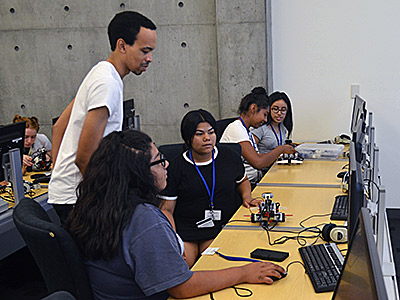 Graduate student Lorenzo Booth teaches a robotics workshop during the Upward Bound Academy this summer. 